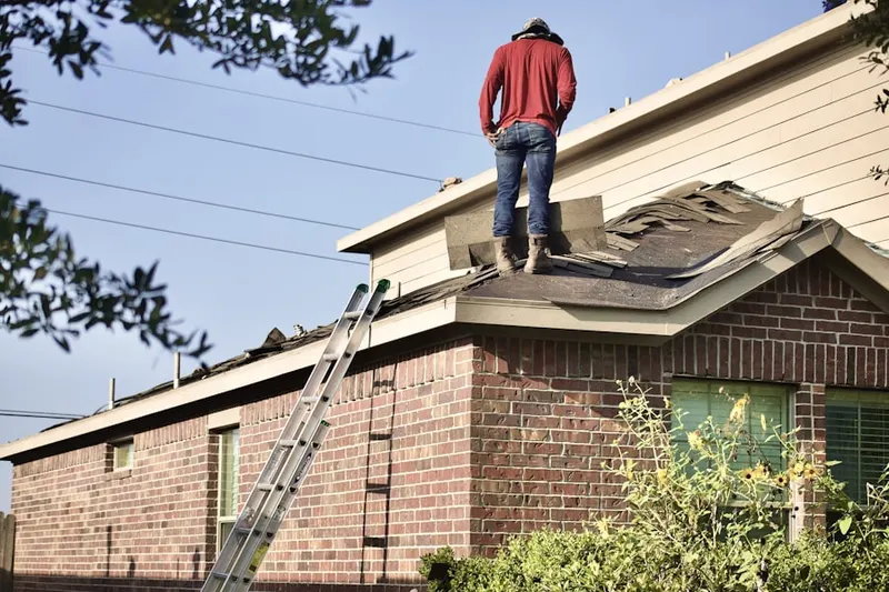 Professional roofer working on a residential roof in Hidden Ridge